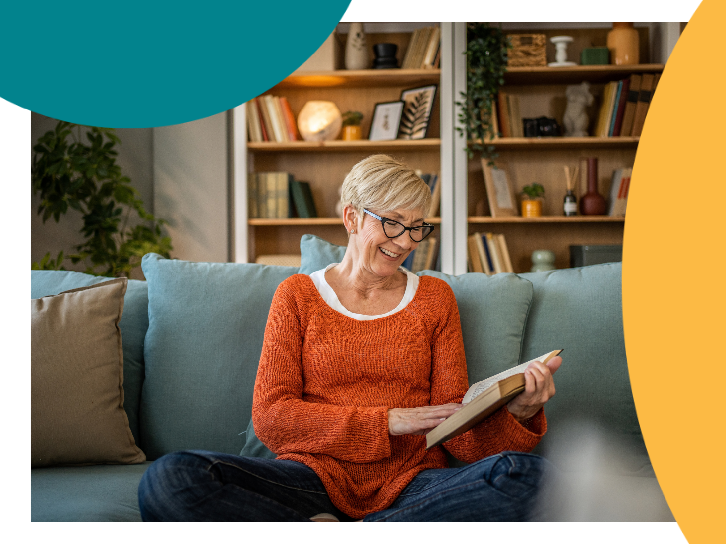 A person relaxing on a couch reading a book