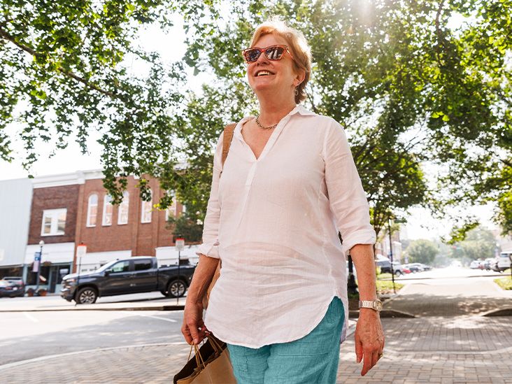 A person walking outdoors on a sunny day