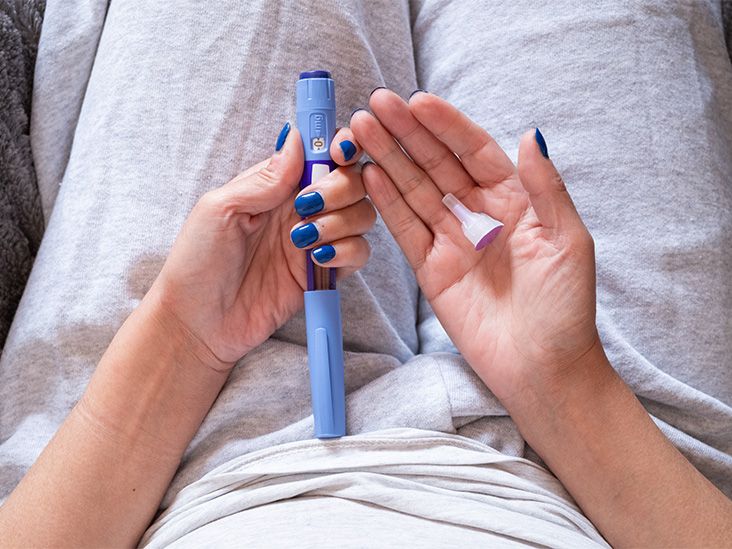 A person holding a GLP-1 injection pen