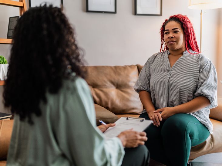 A person talking with a therapist in a bright office