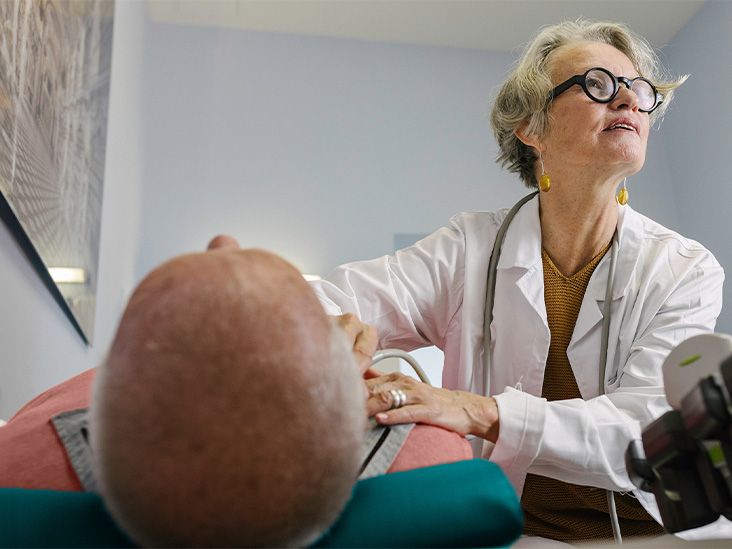 A doctor listening to a patient's heart with a stethoscope