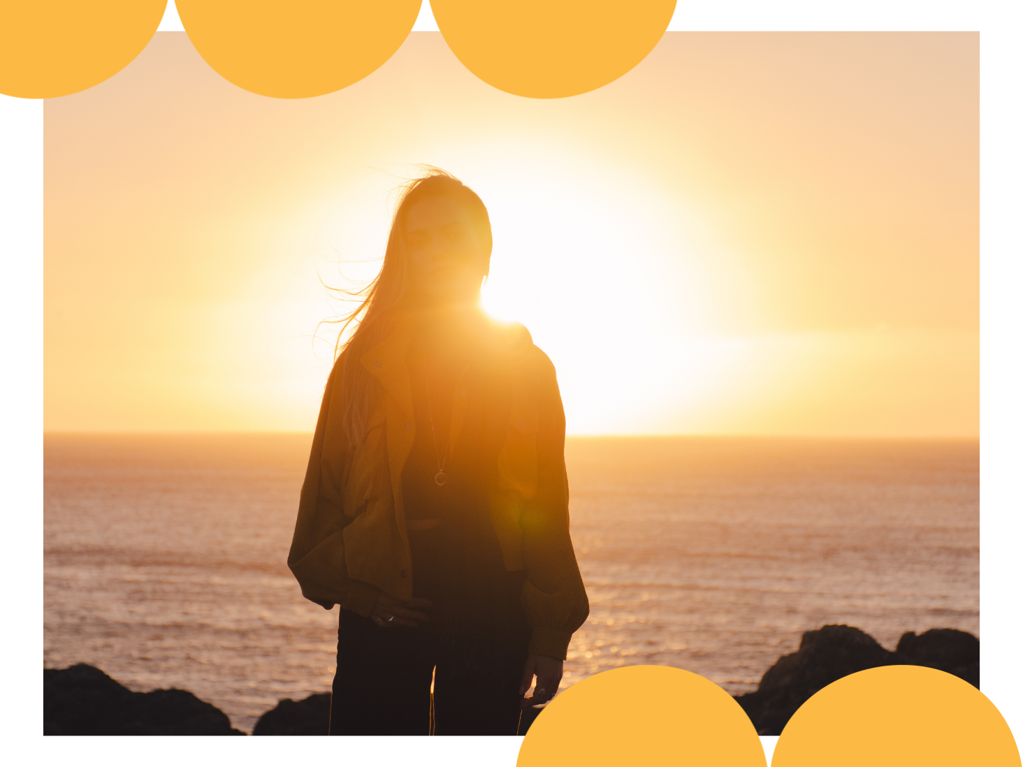 A person looking out at the sunset over the ocean