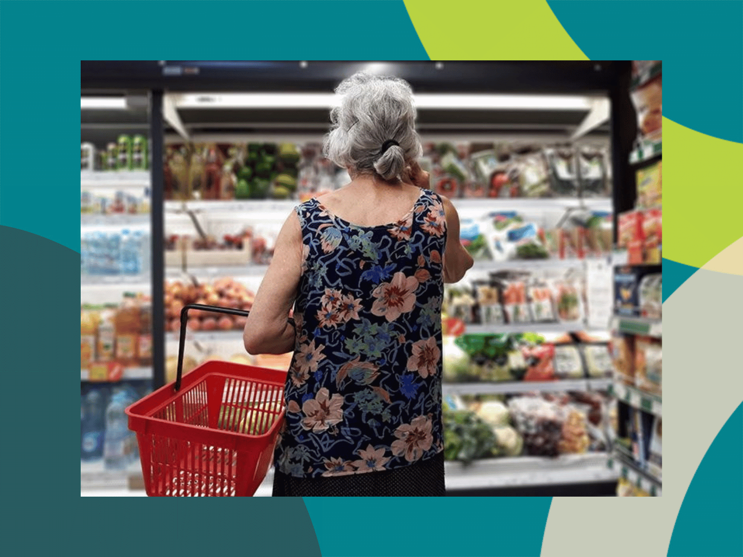 Older woman with a shopping basket browsing a grocery store produce aisle