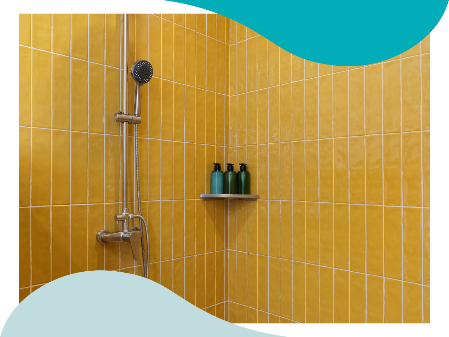 A shower with yellow tile walls and 3 soap bottles on a corner shelf