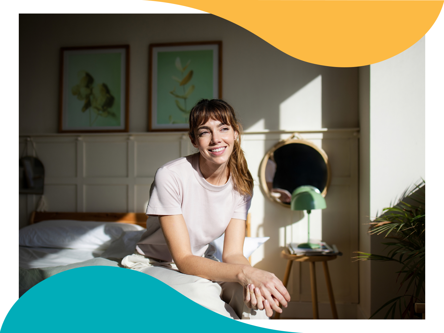 Woman smiling while sitting on her bed in morning sunlight